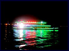 Illuminated boat passing on Pearl River by Shamian Island, seen from Rose Garden.